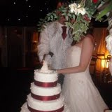 Wedding - £1000's, Flowers - 100's, Only shot of the cake being cut - Priceless. (kidding!)
